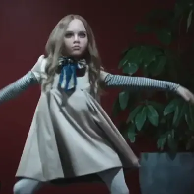 A 4ft blonde doll dancing in an office hallway.