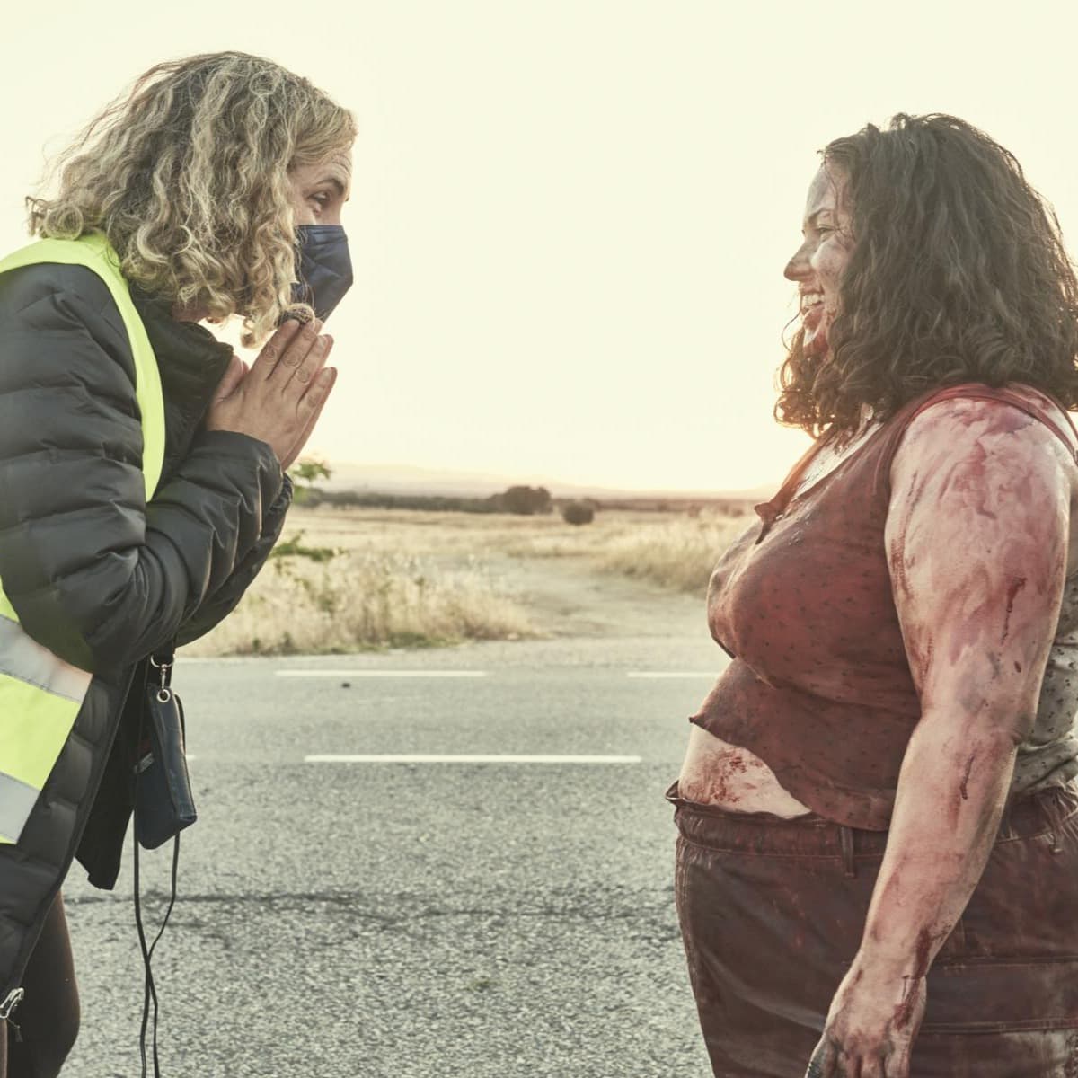 A young girl, covered in blood, talking out of character to the director of the film